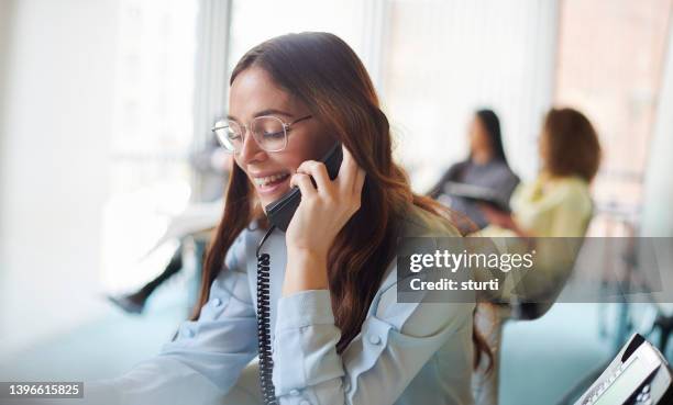 business call - landline phone woman stock pictures, royalty-free photos & images