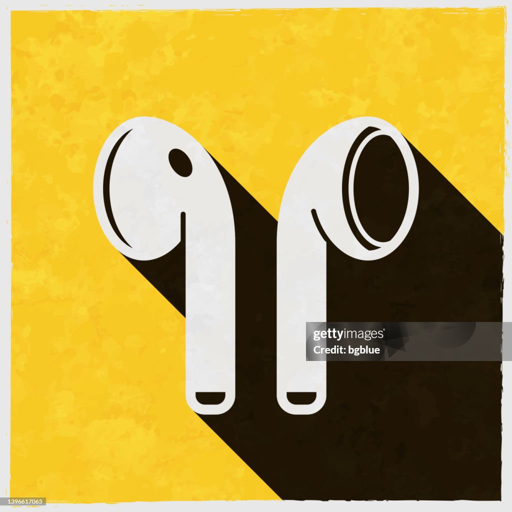 Wireless earphones. Icon with long shadow on textured yellow background