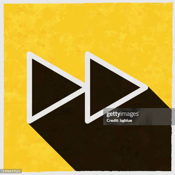 fast forward. icon with long shadow on textured yellow background - fast forward stock illustrations
