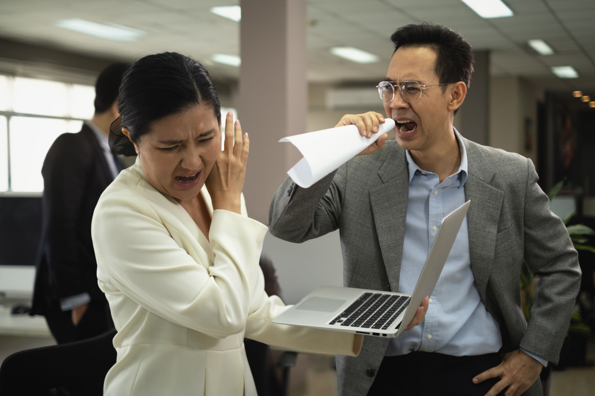 Office employees asian women holding laptop were scolded in the office with Manager people shout louder angry mood to her about problem in job. Problem in an office work Office employees asian women holding laptop were scolded in the office with Manager people shout louder angry mood to her about problem in job. Problem in an office work
