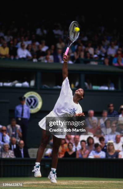 Lori McNeil of the United States reaches to serve to Conchita Martínez of Spain during their Women's Singles Semi Final match at the Wimbledon Lawn...