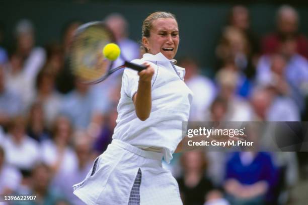 Iva Majoli from Croatia plays a forehand return to Anna Kournikova of Russia during their Women's Singles Quarter Final match at the Wimbledon Lawn...