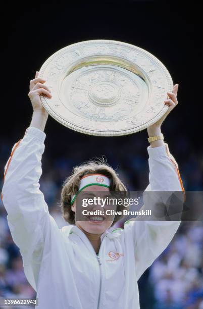 Martina Hingis from Switzerland holds the Venus Rosewater Dish aloft after winning the Women's Singles Final match on Centre Court against Jana...