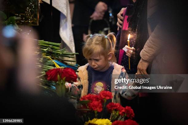 Daughter of junior sergeant of the Armed Forces of Ukraine Ruslan Borovyk, known as Bahdad, cries near father's coffin during a memorial service in...