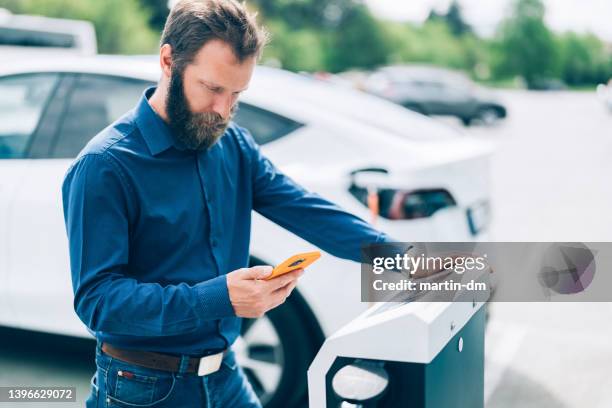 man charging electric car - car nfc stock pictures, royalty-free photos & images