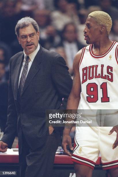 Coach Phil Jackson shoots forward Dennis Rodman of the Chicago Bulls a stern look during a playoff game against the Washington Bullets at the United...