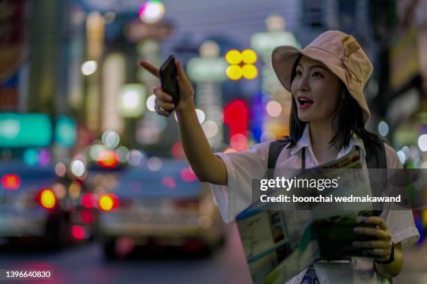 woman traveling in bangkok night city - china town stock pictures, royalty-free photos & images