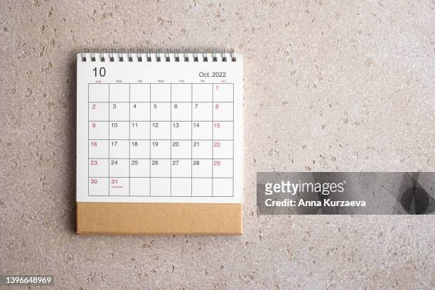 october 2022 desk calendar on concrete background, top view. copy space. - october stock pictures, royalty-free photos & images
