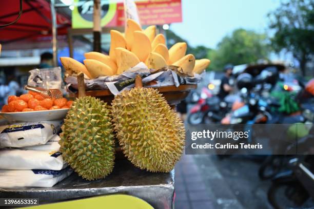 durian at a market stall - durian stock pictures, royalty-free photos & images