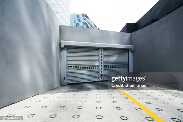 the entrance and exit of the underground parking lot of an office building - roller shutter 個照片及圖片檔