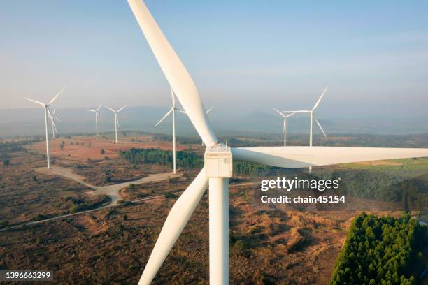 sustainable energy by wind turbine for green world energy. - green economy stock pictures, royalty-free photos & images