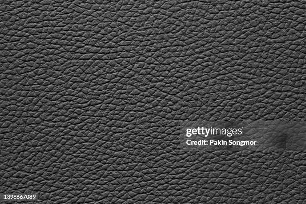 black leather and a textured background. - rindsleder stock-fotos und bilder