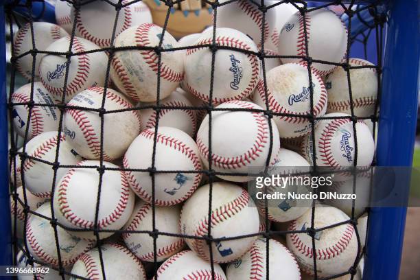 Detail of a cart filled with baseballs is set up for batting practice prior to a game between the Chicago Cubs and the Los Angeles Dodgers at Wrigley...