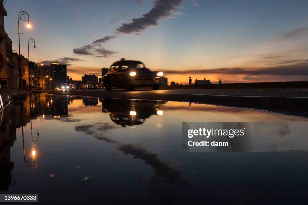 old car on malecon street of havana with colourful sunset in background. cuba - old havana bildbanksfoton och bilder