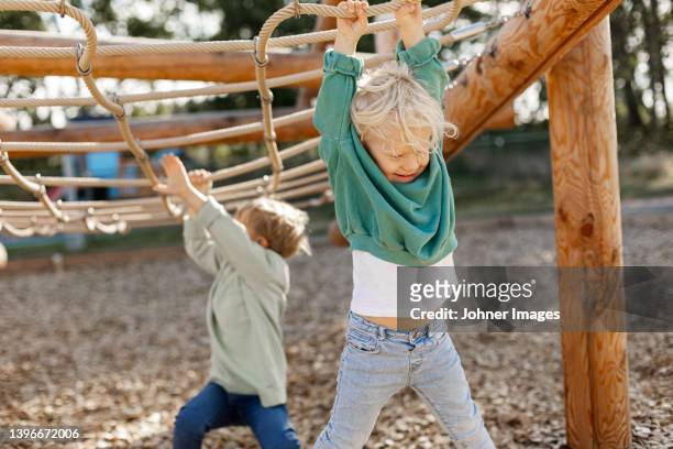 child playing on climbing frame - jungle gym stock pictures, royalty-free photos & images