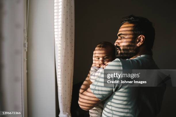 father holding baby - parental leave stock pictures, royalty-free photos & images