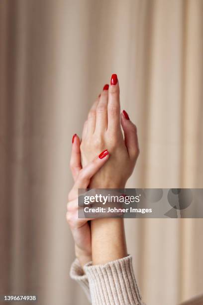 close-up of female hands with red nail polish - red nail polish stockfoto's en -beelden