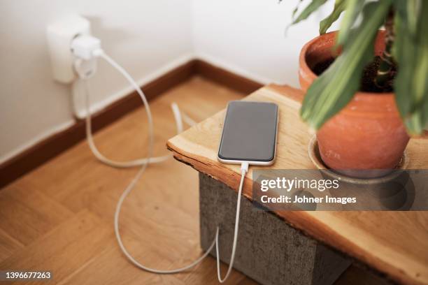 view of charging cell phone - electrical outlet stock pictures, royalty-free photos & images