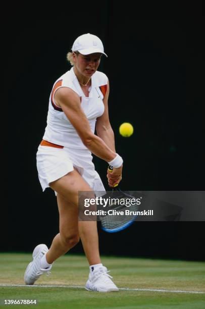 Kim Clijsters from Belgium plays a double handed forehand return to Meghann Shaughnessy of the United States during their Women's Singles Fourth...