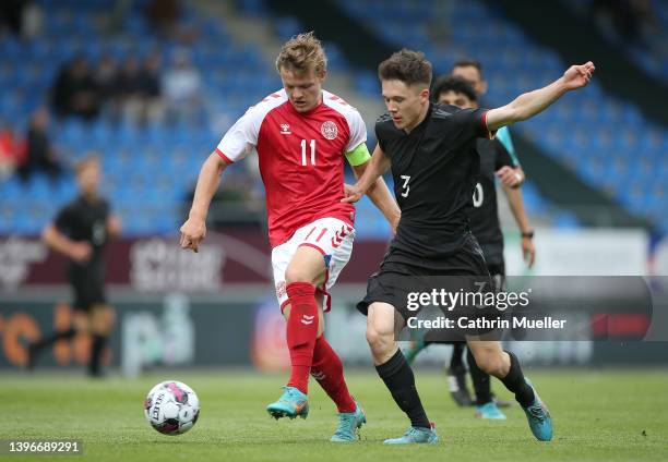 Christian Kjelder Rasmussen of Denmark is challenged by Benjamin Hemcke of Germany during the international friendly match between Denmark U19 and...