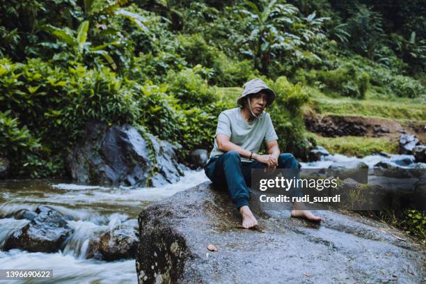 pensive mature man on top of the rock  looking away - mount disappointment stock pictures, royalty-free photos & images