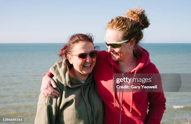 two women by the sea - kent - england stock pictures, royalty-free photos & images