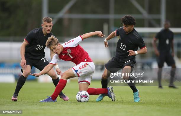 Daniel Haarbo of Denmark is challenged by Kushtrim Asallari and Youssef Amyn of Germany during the international friendly match between Denmark U19...