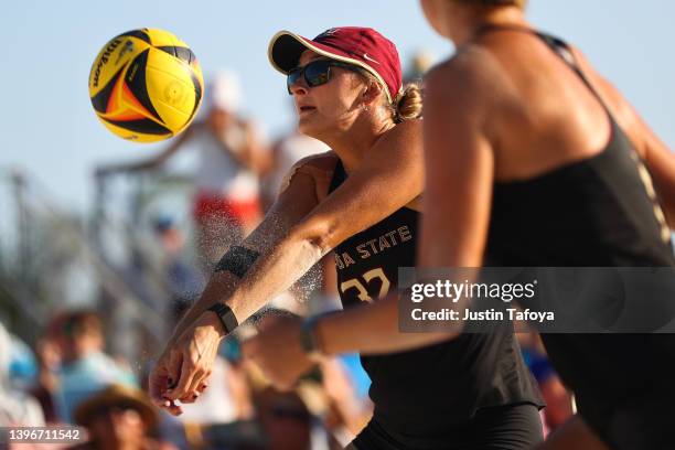 Brook Bauer of the Florida State Seminoles bumps a ball to her teammate as they take on the USC Trojans during the Division I Women's Beach...