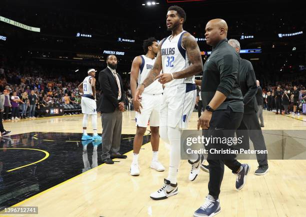 Marquese Chriss of the Dallas Mavericks is escorted off the court during the final moments of Game Five of the Western Conference Second Round NBA...