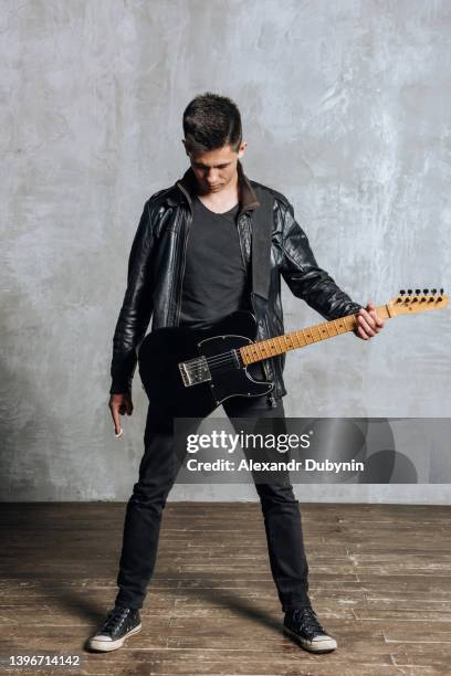 confident man guitarist with guitar - music artist stock pictures, royalty-free photos & images