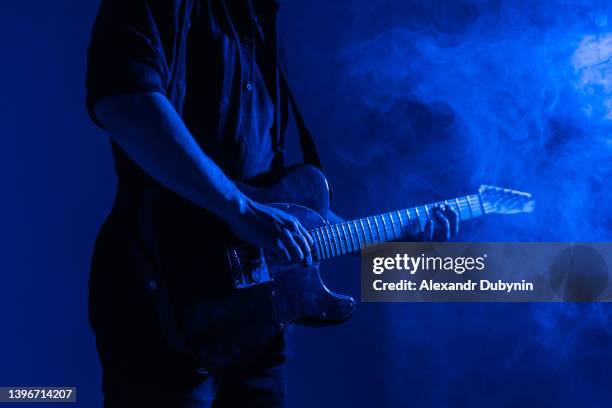 guitar advertising banner. male guitarist plays music in neon light with smoke. - gitarist stockfoto's en -beelden