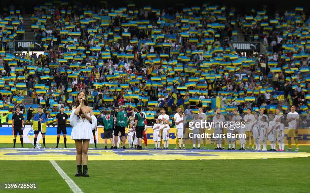 An actress sings the national anthem of Ukraine prior to the charity match between Borussia Mönchengladbach and Ukraine at Borussia-Park on May 11,...