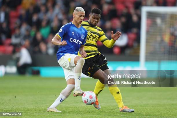 Richarlison of Everton is challenged by Christian Kabasele of Watford FC during the Premier League match between Watford and Everton at Vicarage Road...
