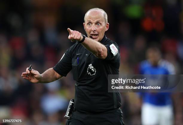 Referee, Mike Dean reacts during the Premier League match between Watford and Everton at Vicarage Road on May 11, 2022 in Watford, England.