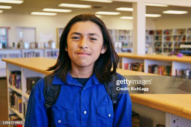 high school student in a library - boy with long hair stock pictures, royalty-free photos & images