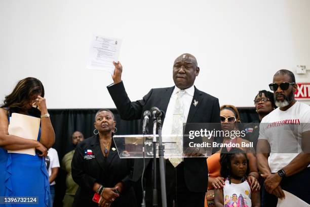 Attorney Ben Crump holds up the autopsy report of Jalen Ja'Von Randle during a news conference on May 11, 2022 in Houston, Texas. The news conference...