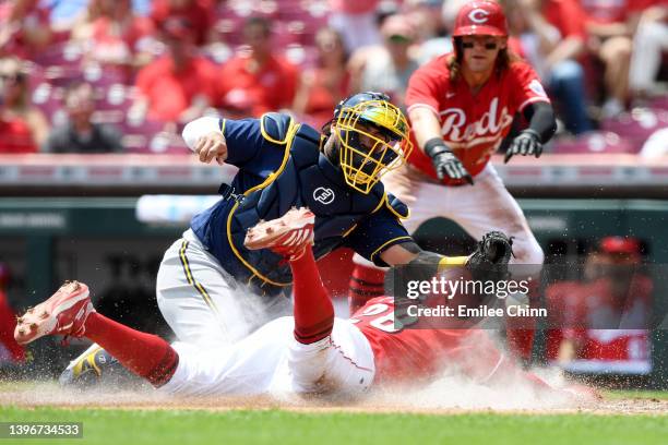 Tommy Pham of the Cincinnati Reds slides safely into home base against Omar Narvaez of the Milwaukee Brewers on an three RBI double by Tyler...