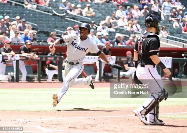 Jesus Sanchez of the Miami Marlins scores on a single by Jacob Stallings against the Arizona Diamondbacks during the second inning at Chase Field on...