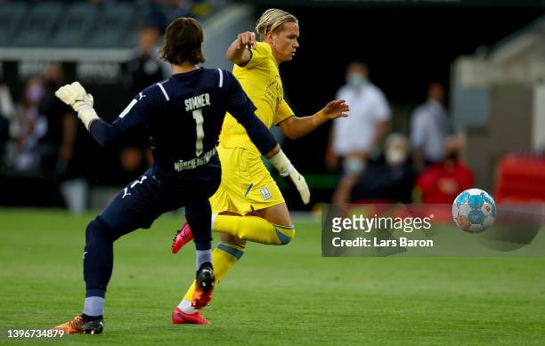 Mykhailo Mudryk of Ukraine runs past goalkeeper Jan Sommer of Moenchengladbach to score his teams first goal during the charity match between...
