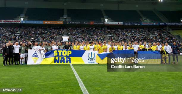 Players of both teams stand together for peace prior to the charity match between Borussia Mönchengladbach and Ukraine at Borussia-Park on May 11,...