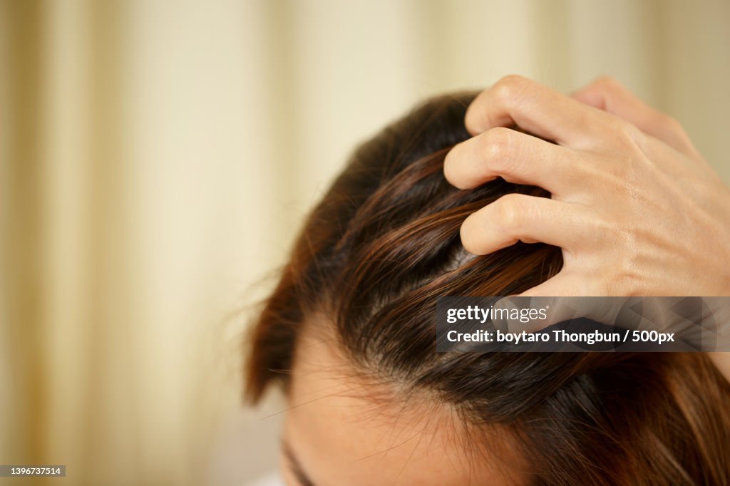 A woman has problems with hair,Close-up of woman with hand in hair