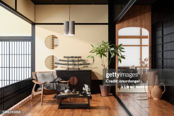 japanese style living room interior with armchair, coffee table, potted plant, dining table and sofa - when travel was a thing of style stockfoto's en -beelden