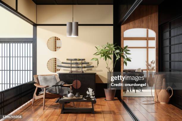 japanese style living room interior with armchair, coffee table, potted plant, dining table and sofa - japanese decor stock pictures, royalty-free photos & images