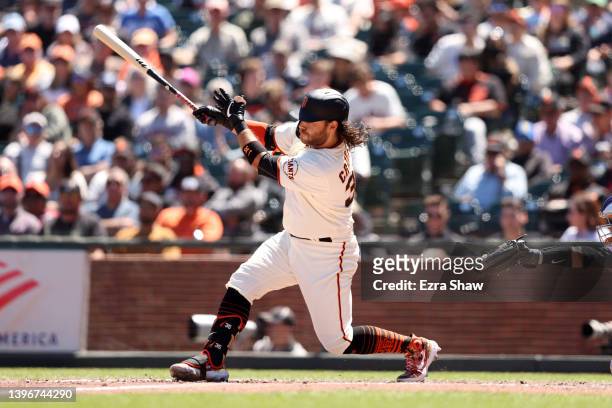 Brandon Crawford of the San Francisco Giants hits a two-run home run in the fifth inning against the Colorado Rockies at Oracle Park on May 11, 2022...