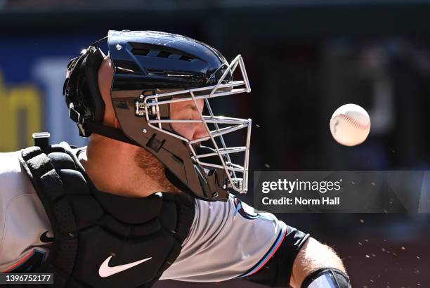 Jacob Stallings of the Miami Marlins takes a ball off his mask against the Arizona Diamondbacks during the ninth inning at Chase Field on May 11,...