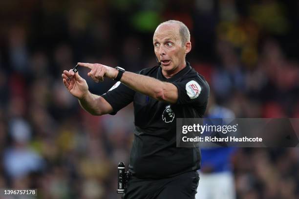 Referee Mike Dean gives instructions during the Premier League match between Watford and Everton at Vicarage Road on May 11, 2022 in Watford, England.