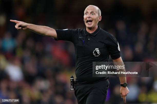 Referee Mike Dean gives instructions during the Premier League match between Watford and Everton at Vicarage Road on May 11, 2022 in Watford, England.