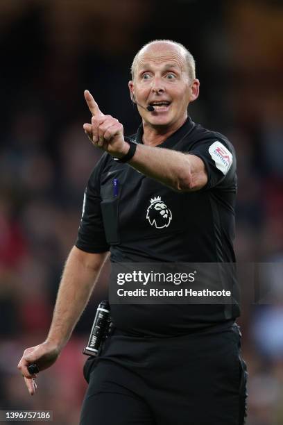 Referee Mike Dean gives instructions during the Premier League match between Watford and Everton at Vicarage Road on May 11, 2022 in Watford, England.