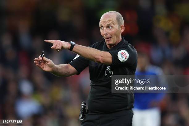 Referee Mike Dean gives instructions during the Premier League match between Watford and Everton at Vicarage Road on May 11, 2022 in Watford, England.