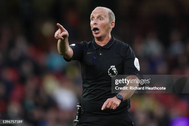 Referee Mike Dean gives instructions during the Premier League match between Watford and Everton at Vicarage Road on May 11, 2022 in Watford, England.